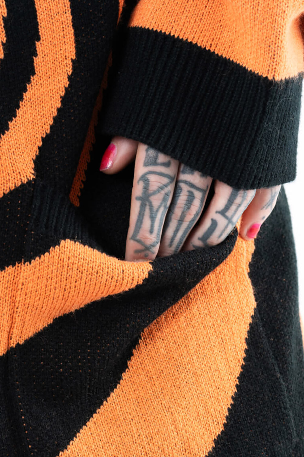 oversized knitted black and orange spiral sweater