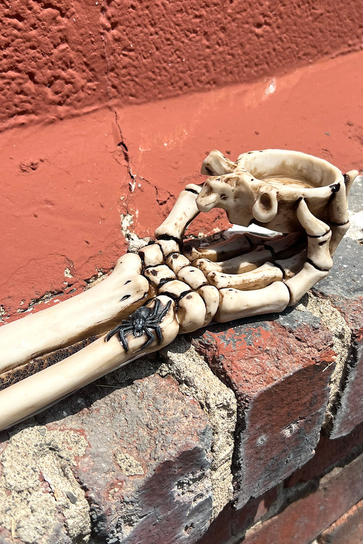 Quemador de velas con forma de mano de esqueleto