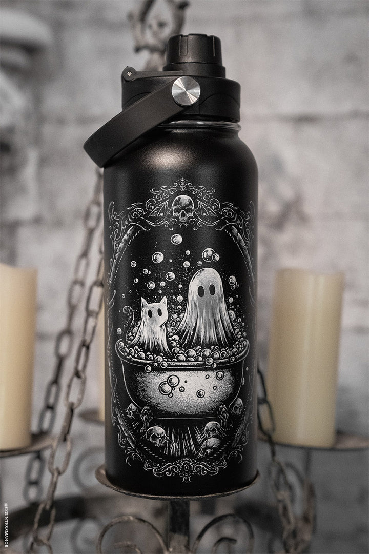 Black water bottle with ghost and cat design against a gray background