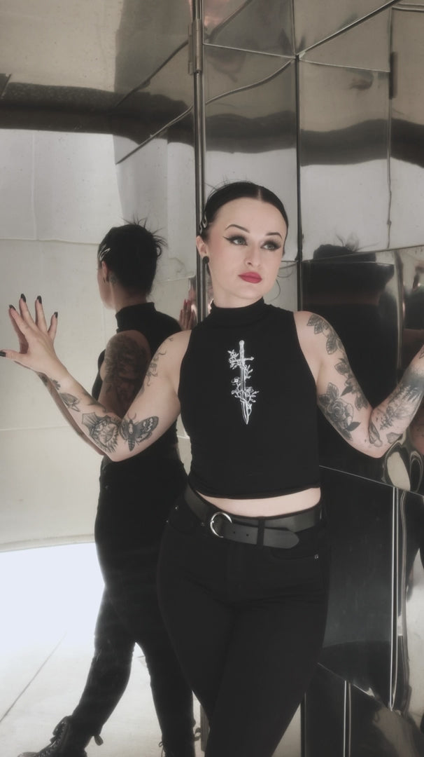 goth girl wearing gothic crop top with printed sword graphic