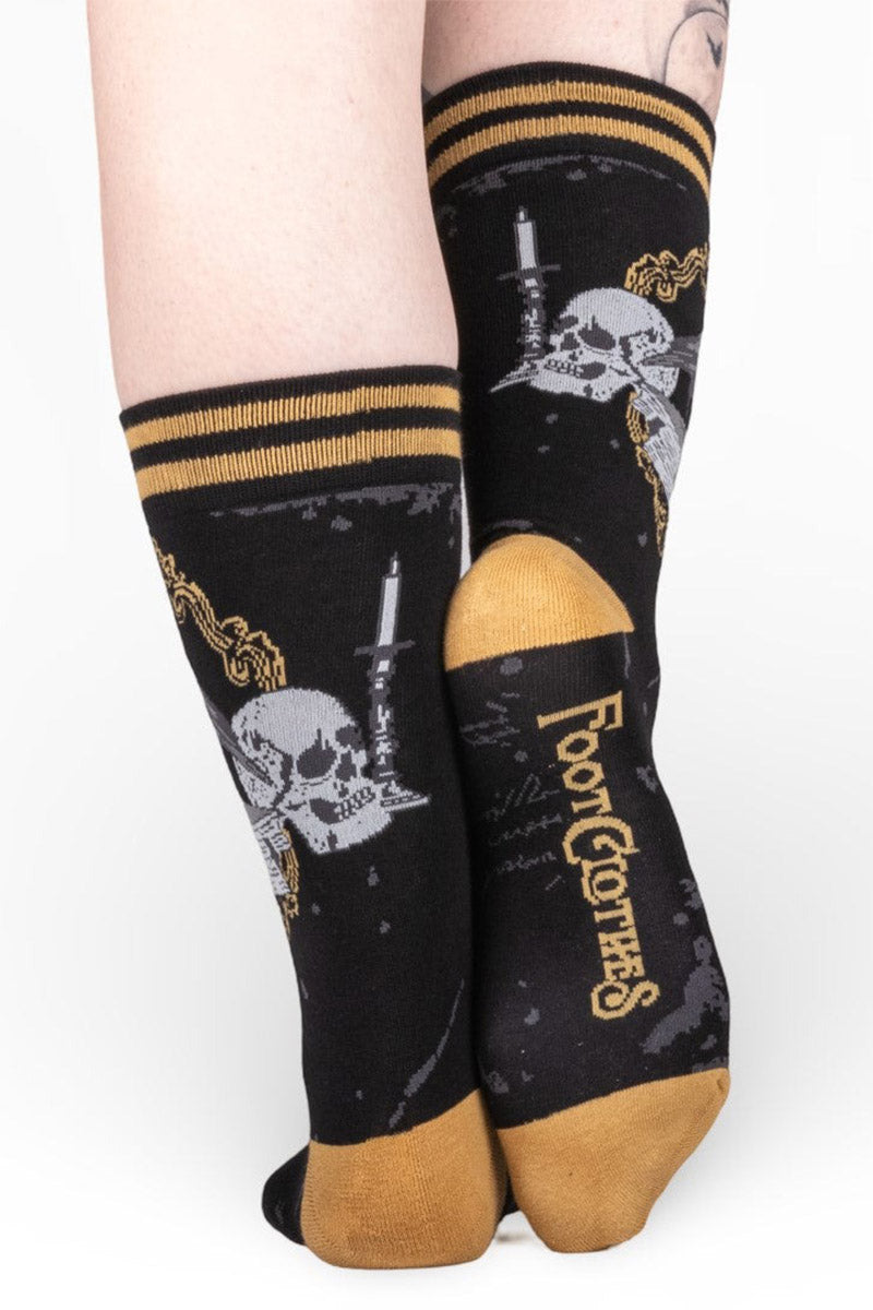 raven socks with knitted books and moons and skulls