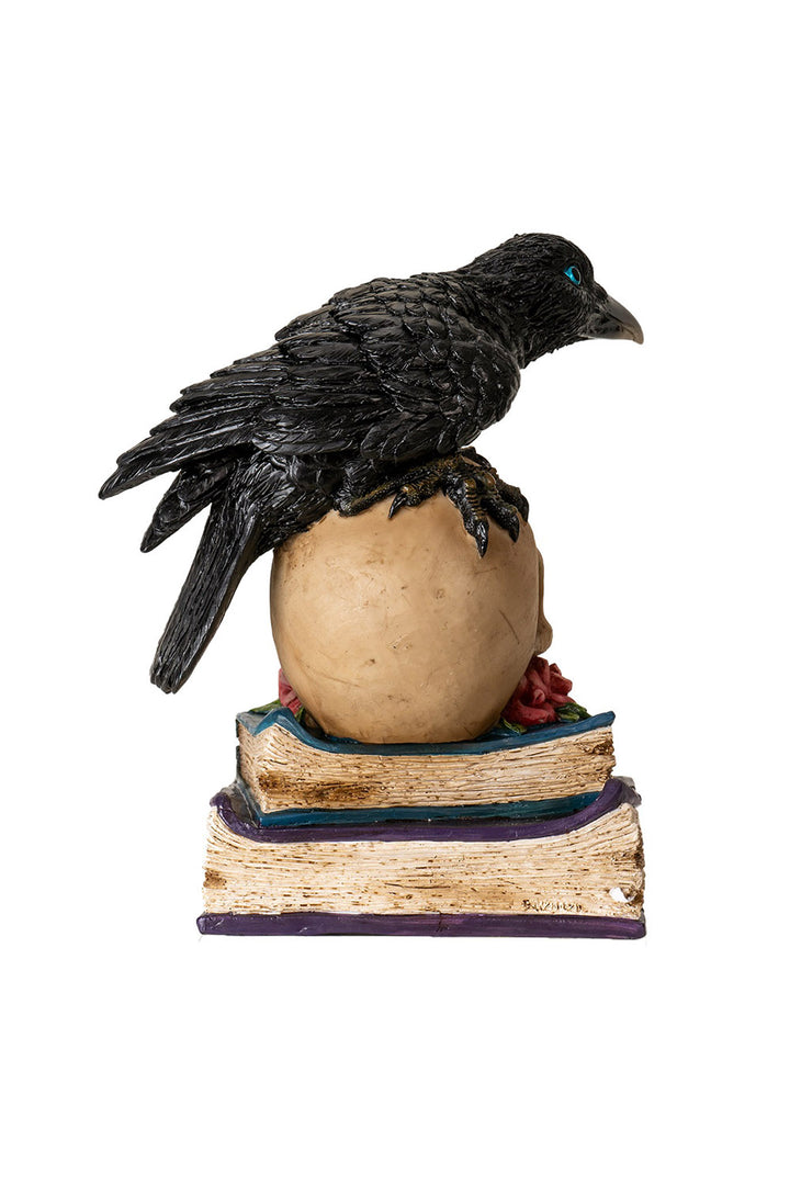 steampunk raven sitting on skull statue