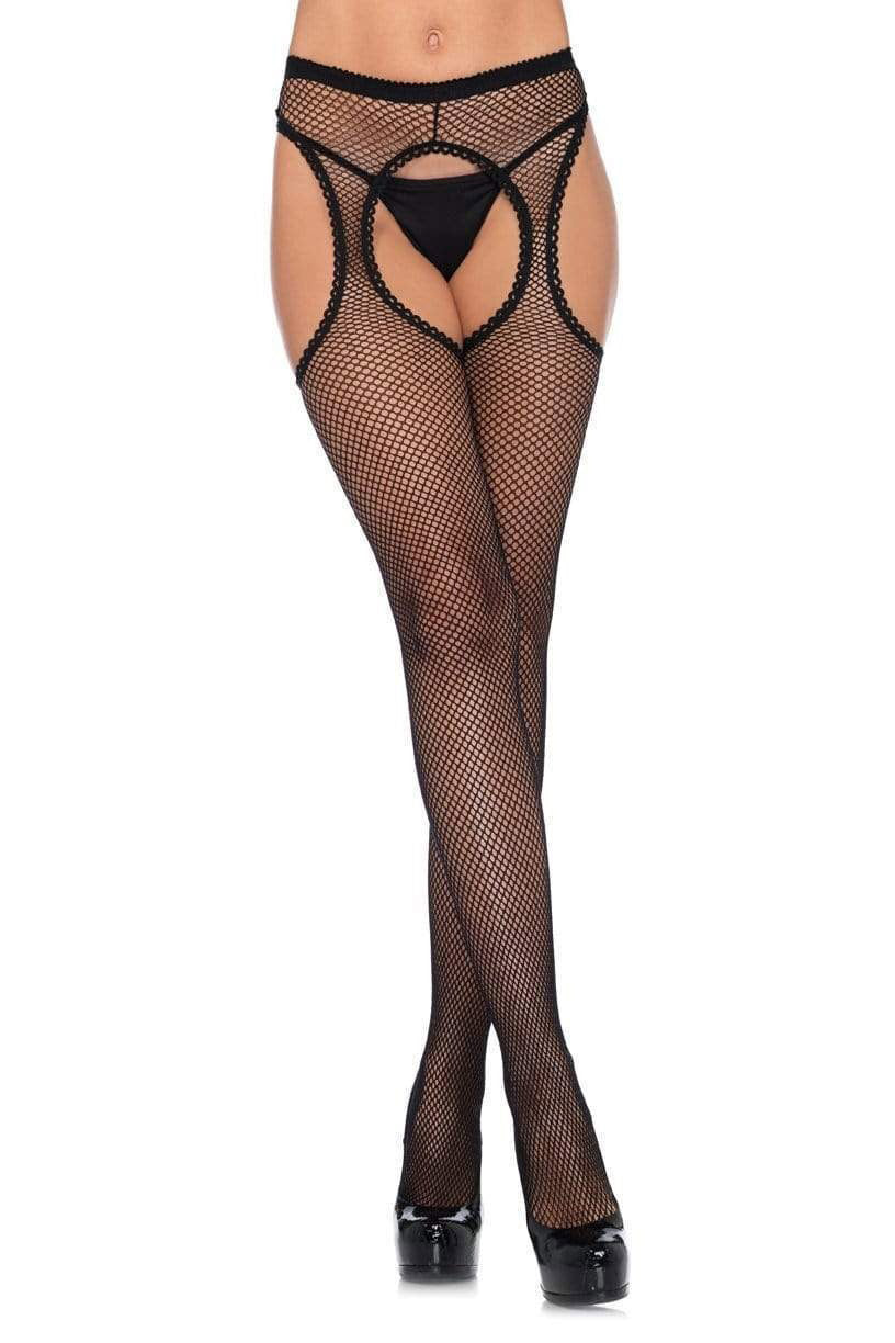 Black fishnet suspender tights with scalloped edges and cutout details at the thighs. The tights feature a soft waistband and are shown on a model wearing high heels.