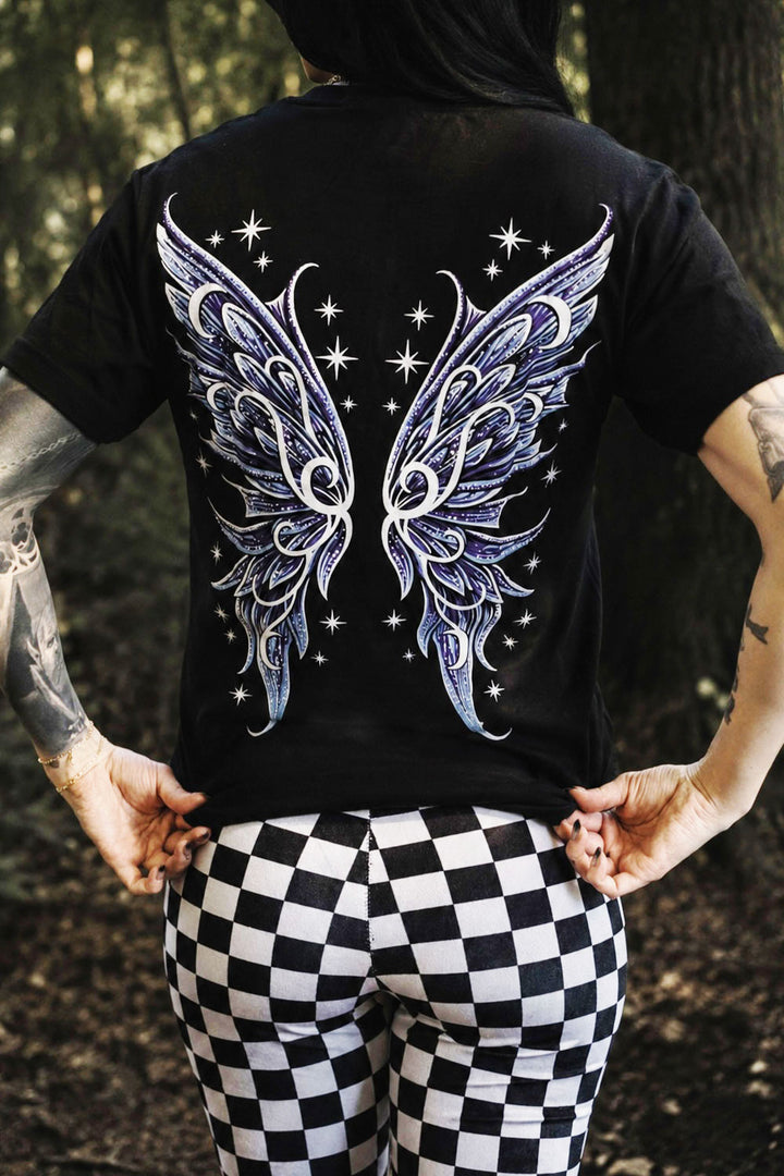 Person wearing a black t-shirt with fairy wings design outdoors