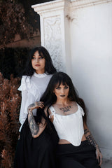 romantic goth white corset top with asymmetrical hem and lace trim