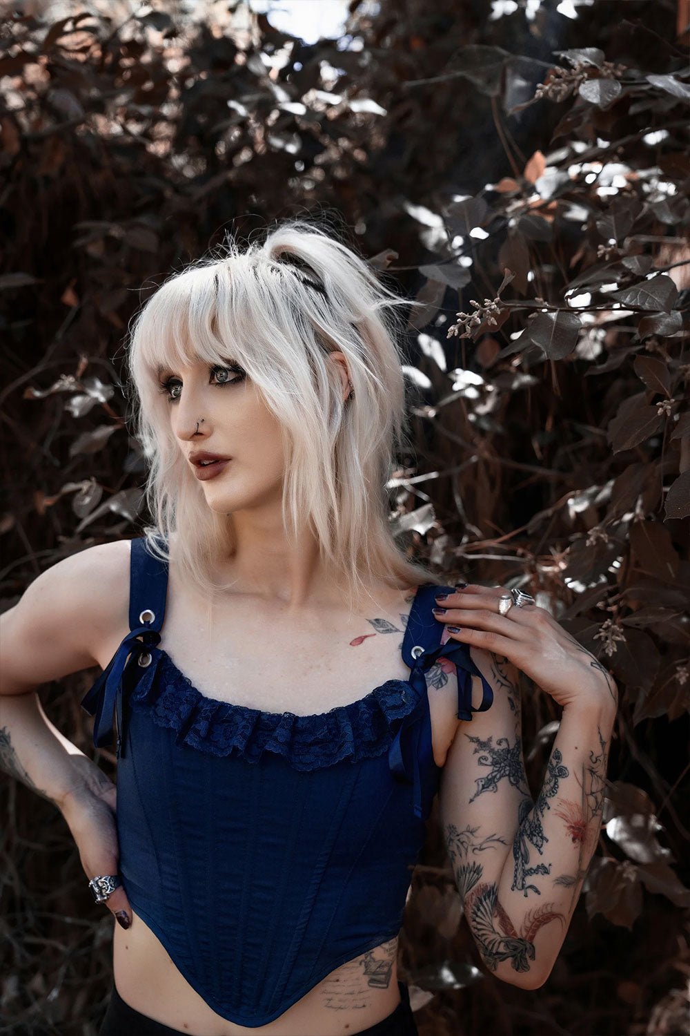dark blue corset with built-in boning structure, lace embellishment on neckline, satin webbing connection