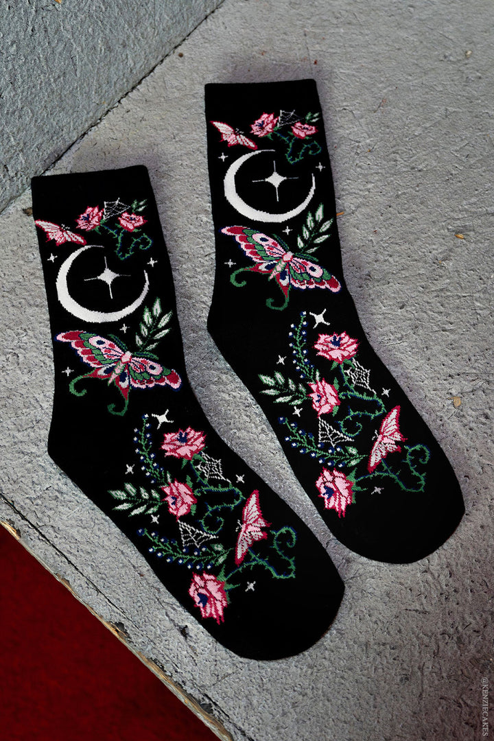 pink and green knitted witchy cottagecore moth and moon socks