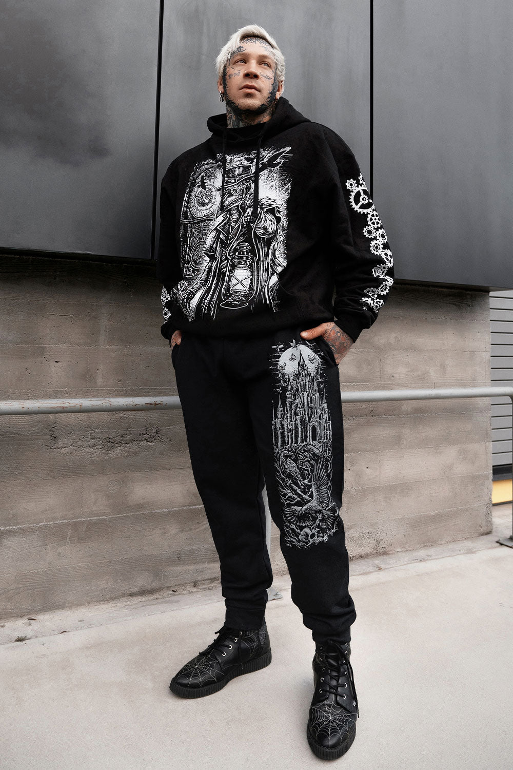 sweatpants with full moon and raven castle printed on them
