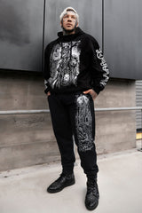 sweatpants with full moon and raven castle printed on them