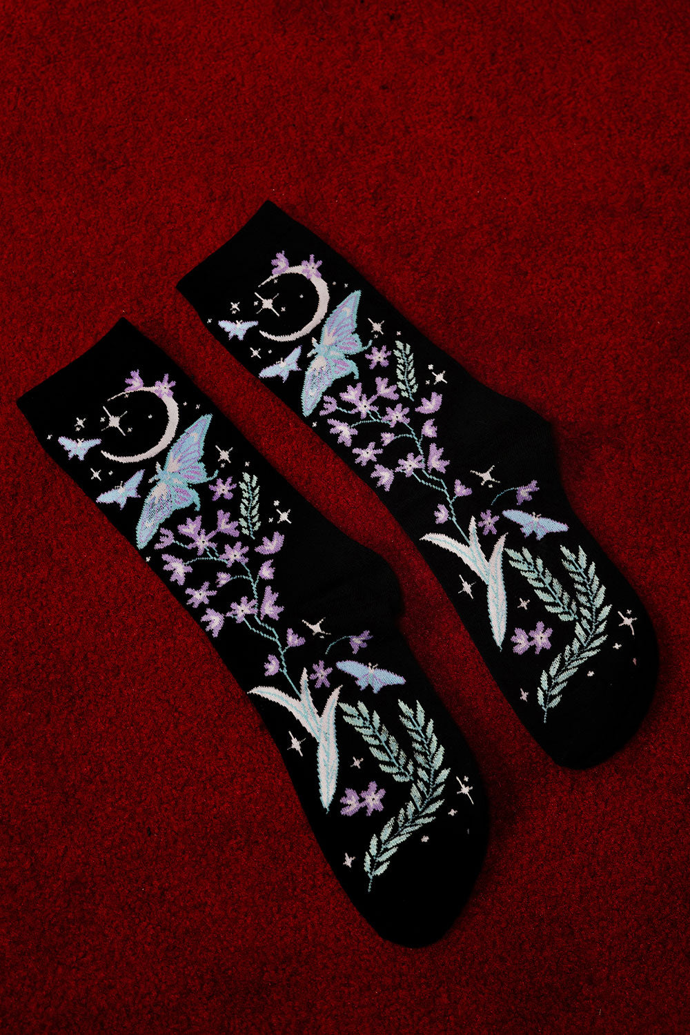 gothic enchanting knitted socks featuring moons, moths, and flowers