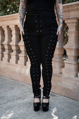 gothic black lace up trousers for women with edgy details for punk rock outfits emo fashion and dark grunge aesthetics