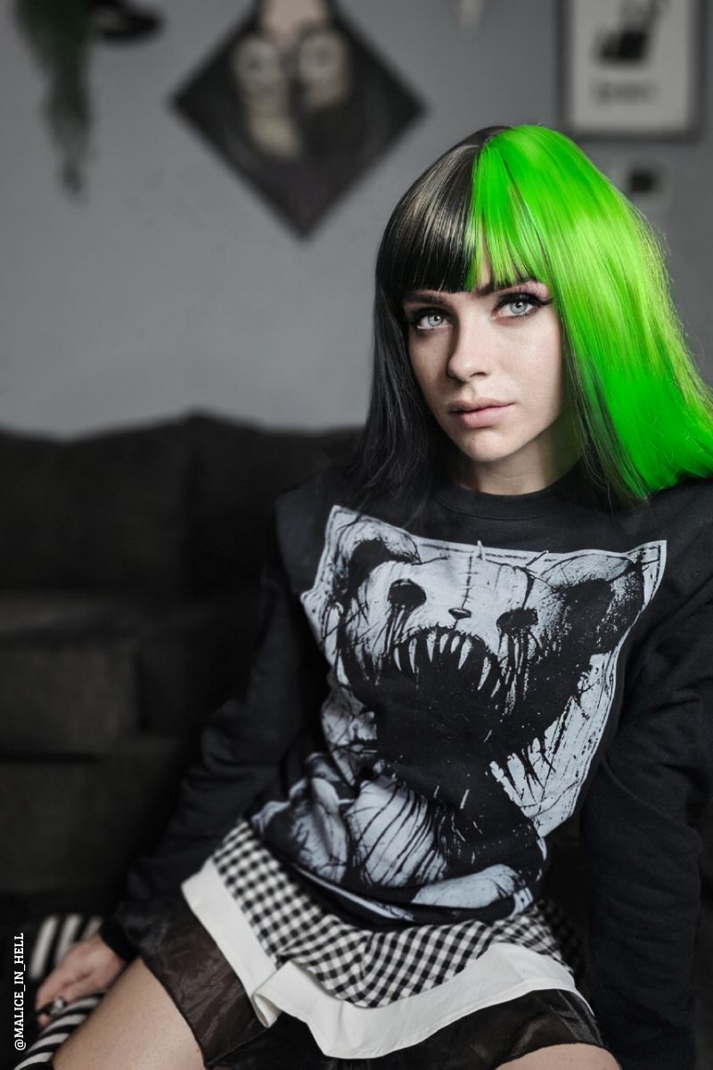 gothic woman with green hair wearing an emo teddy bear sweater
