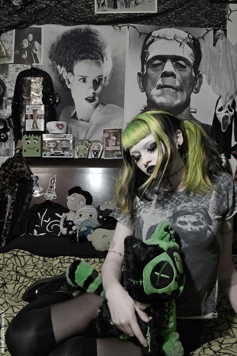 gothic girl holding a frankenstein cat plush stuffed animal 