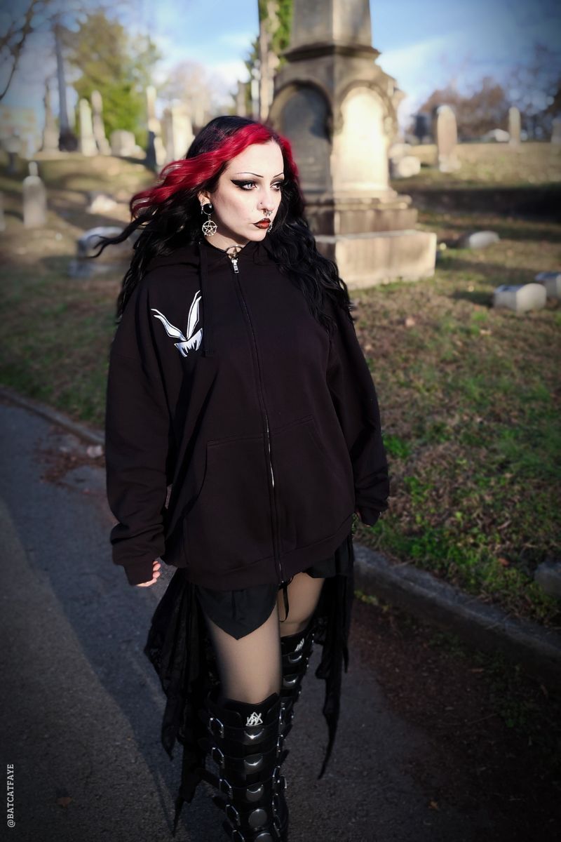 gothic girl wearing a oversized gothic cotton black hoodie jacket 