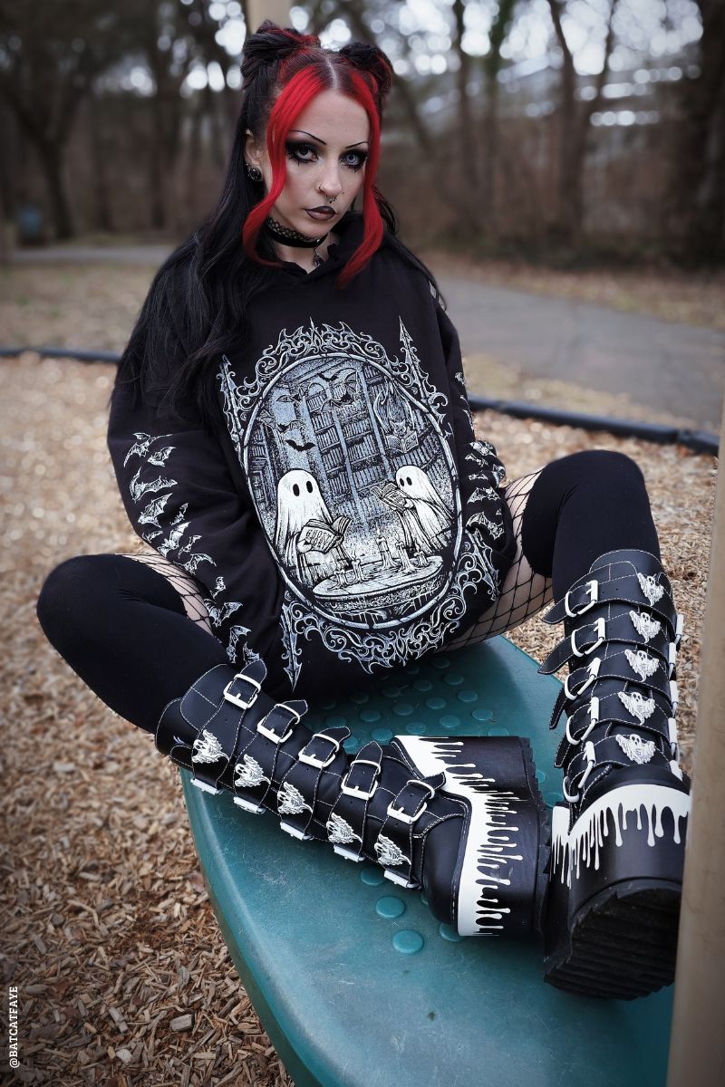 emo girl wearing a black cotton oversized ghost hoodie and matching ghost boots 