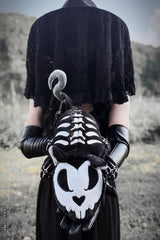 Gothic woman holding a skeleton rat plushie 