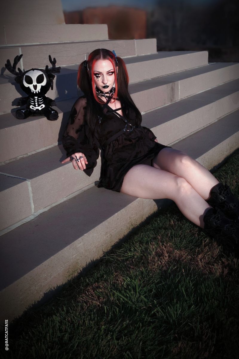 emo woman and a stuffed skeleton wendigo animal 