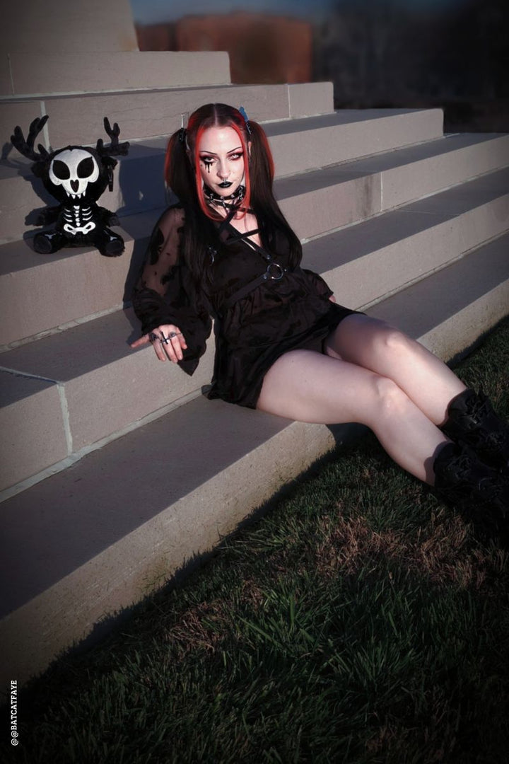 emo woman and a stuffed skeleton wendigo animal 