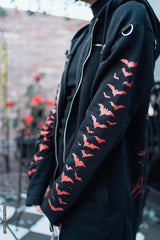 scene woman wearing a gothic hoodie with bat sleeves