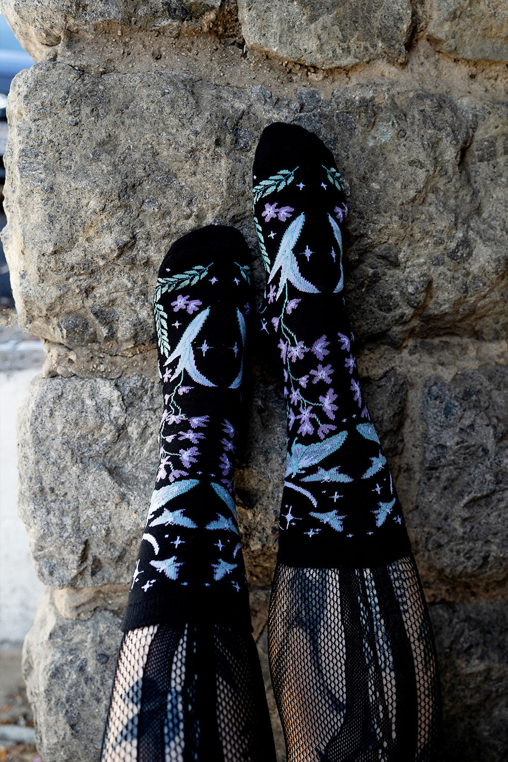 enchanting fairytale knitted socks featuring moons, moths, and flowers