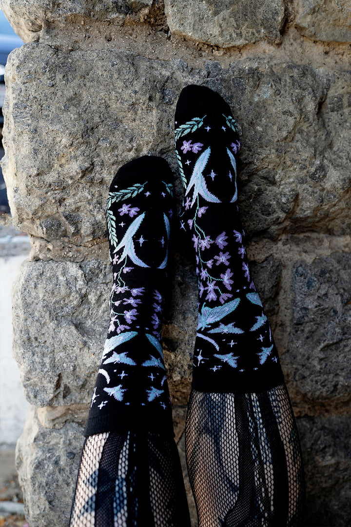 enchanting fairytale knitted socks featuring moons, moths, and flowers
