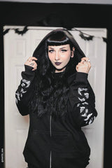 gothic woman wearing a gothic bat hoodie with bat sleeves