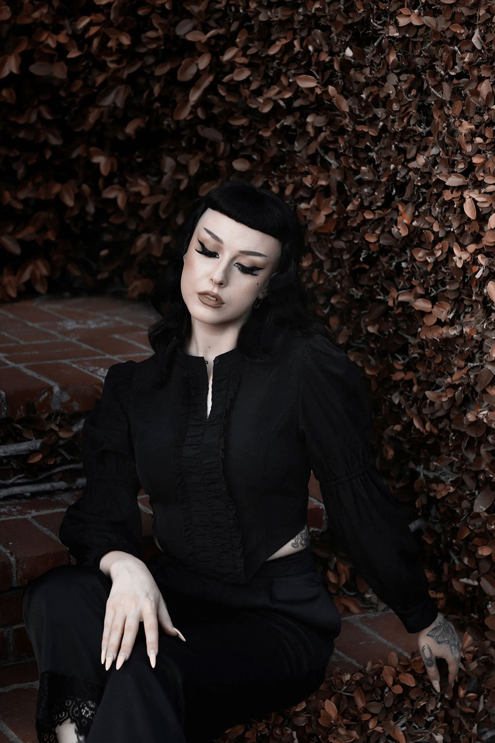Inkspill Blouse decorated with front ruffle trim, puffed two-piece long sleeves & special pointed asymmetrical hem