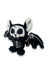 Black and white skeleton plush toy with bat wings on a white background