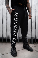 black jogger pants with bats printed on them