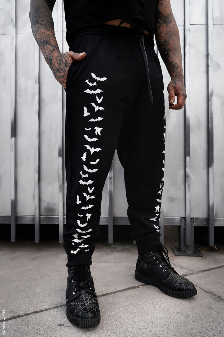 black jogger pants with bats printed on them