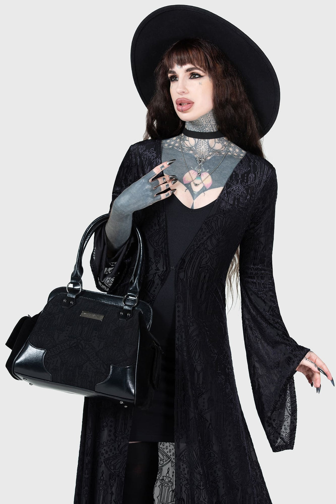 womens holding a beautiful vegan leather damask handbag