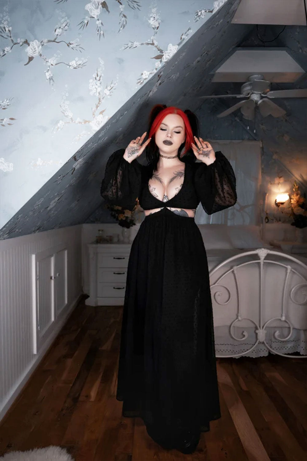 Model wearing black goth dress with cut out waist