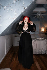 Model wearing black goth dress with cut out waist