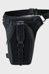 Black leather holster with belt on a light gray background