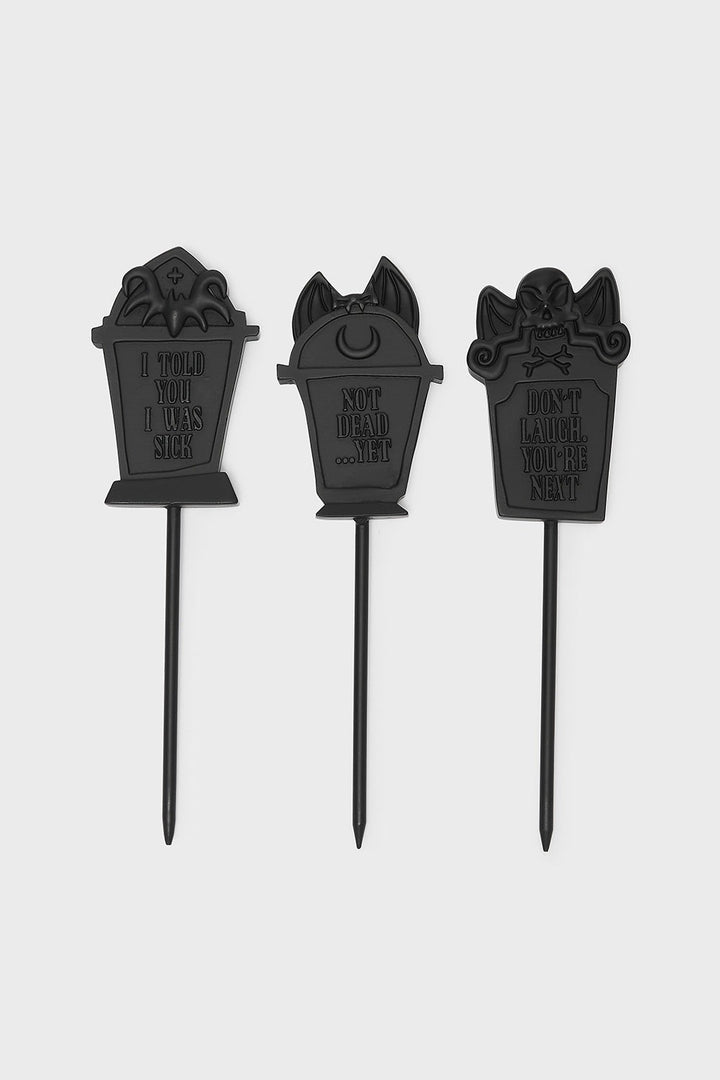 Three black tombstone-shaped plant markers on a white background by killstar