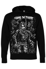 A black pullover hoodie featuring a large white graphic print of a skeletal figure with a skull face, surrounded by dark birds and the text 'HANG IN THERE' across the chest.