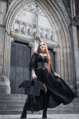 Model holding occult black suede moth backpack