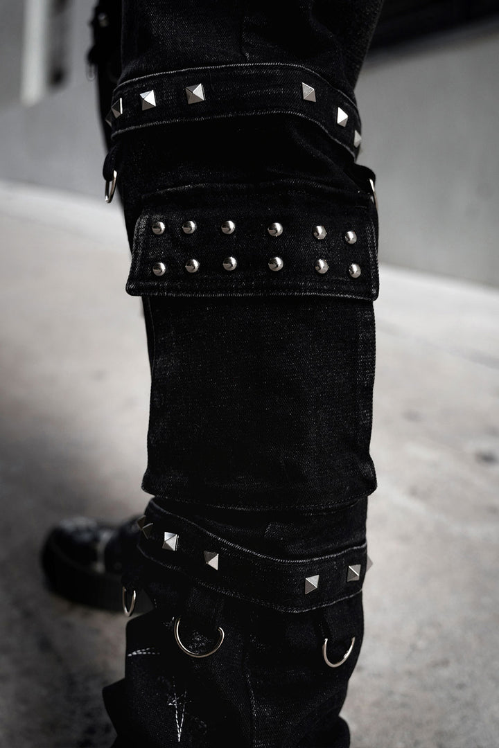 gothic mens pants with studs, exposed stitches, and d-rings in an aged wash