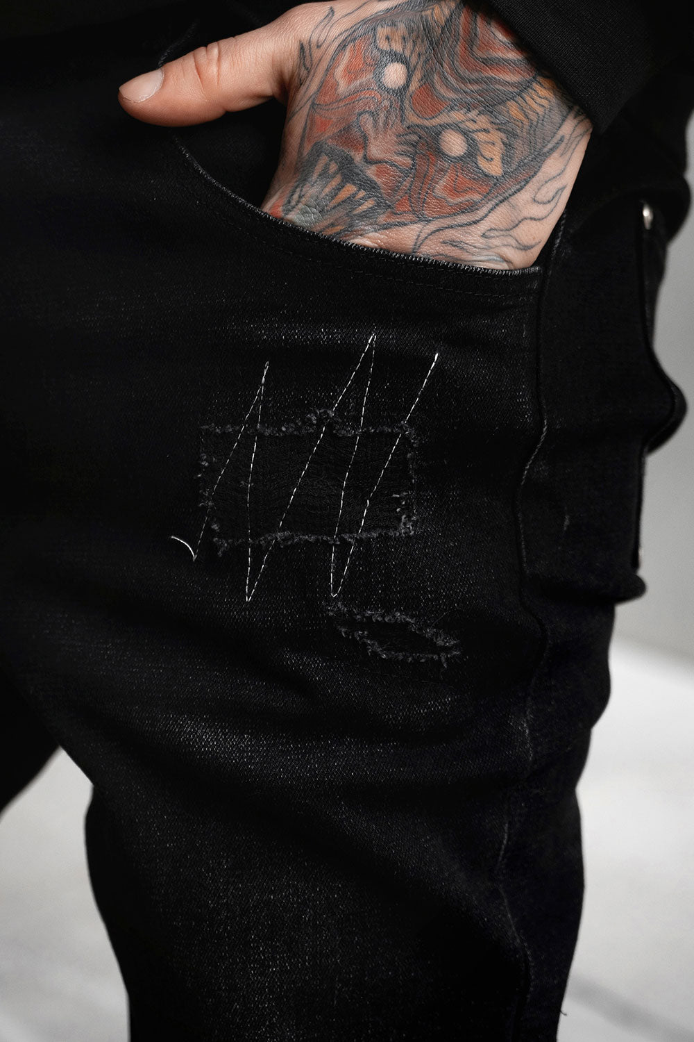 gothic mens pants with studs, exposed stitches, and d-rings