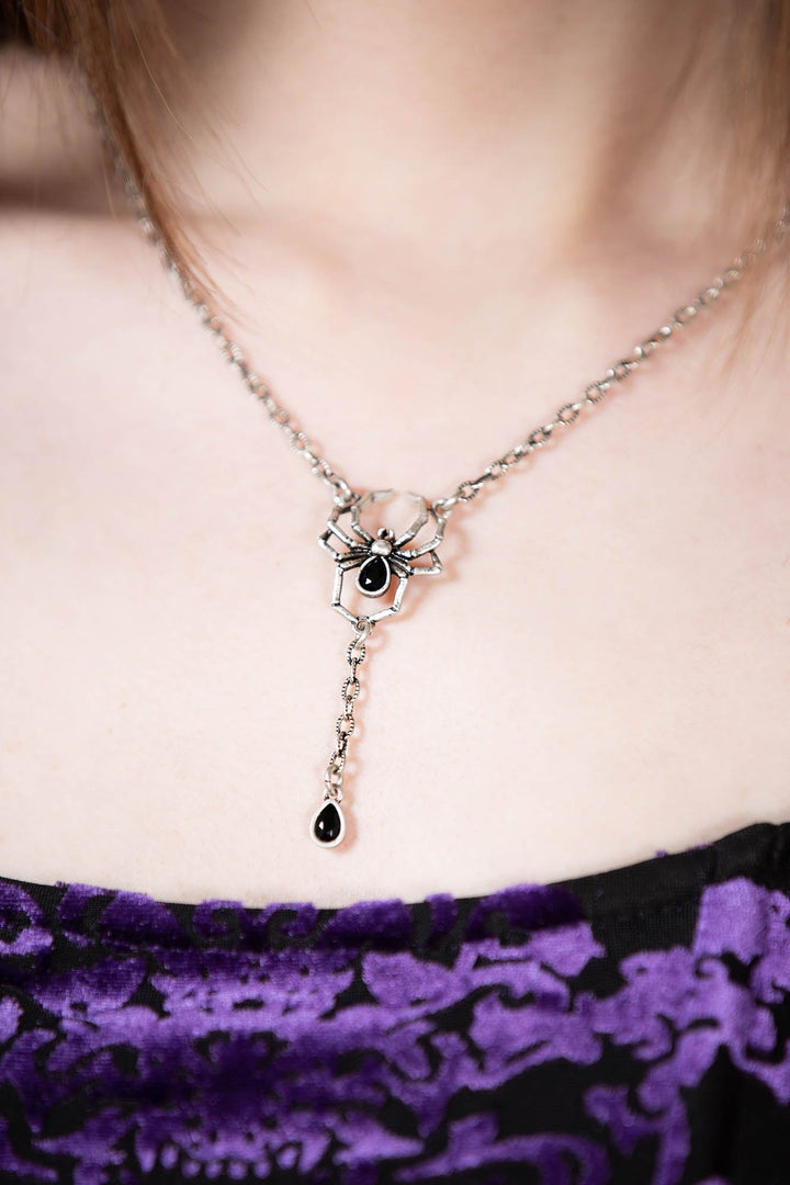 silver necklace with black spider charm