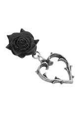Black rose with a silver heart-shaped pendant earring on a white background