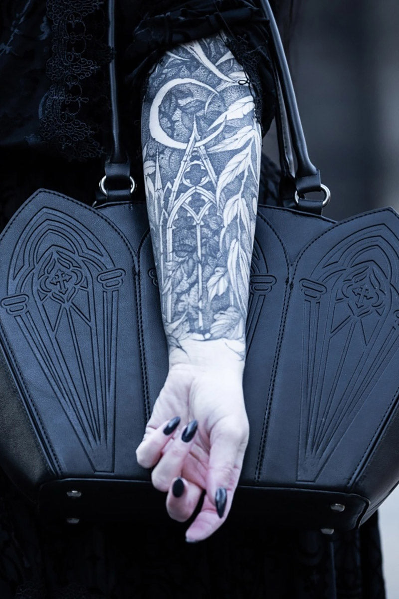 laser cut gothic cathedral shoulder bag with detachable shoulder strap and with red interior lining 