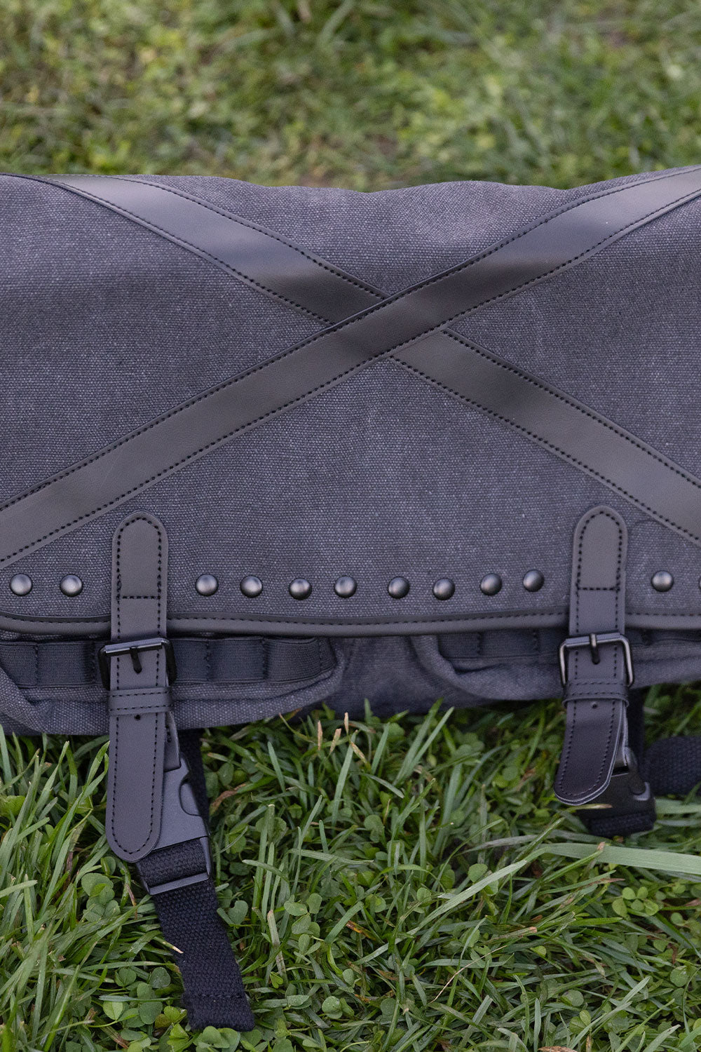 Dark alternative tactical shoulder bag with distressed grey fabric metal D rings and utility pouches for punk grunge and emo outfits