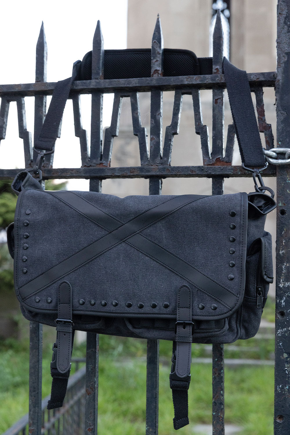 VampireFreaks Grave Dust tactical messenger bag with distressed grey finish black stud hardware and gothic punk alternative streetwear style