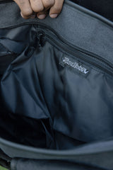 Punk alternative messenger bag in distressed grey wash with black studs adjustable shoulder strap and front pockets for dark streetwear style