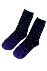 Pair of black socks with purple bat pattern on a white background