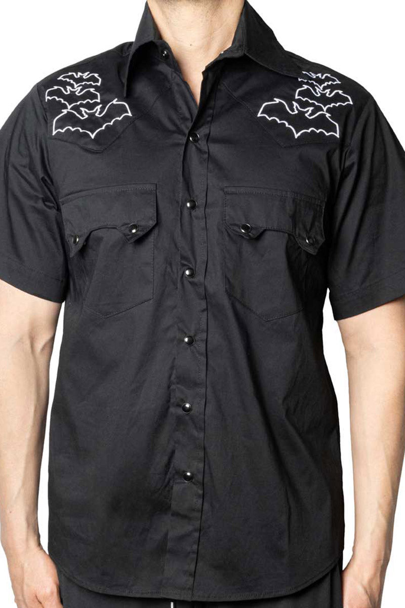 Black short-sleeve shirt with white bat designs on shoulders against a white background