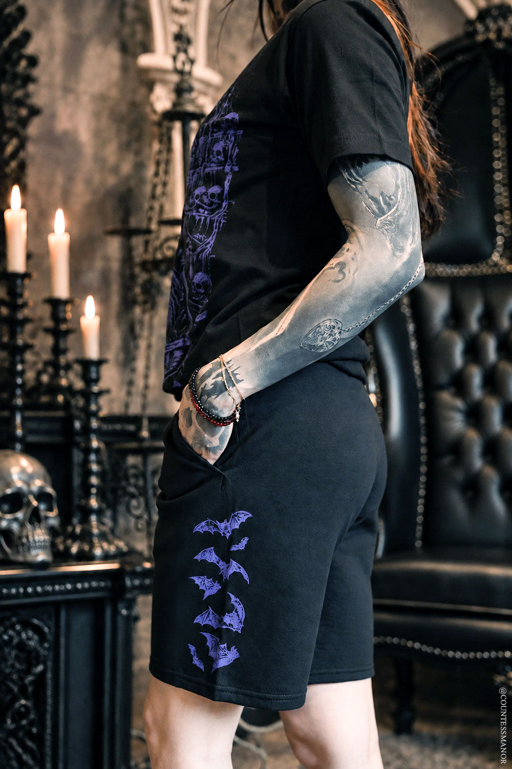 unisex goth black sweat shorts with purple bat graphic on side