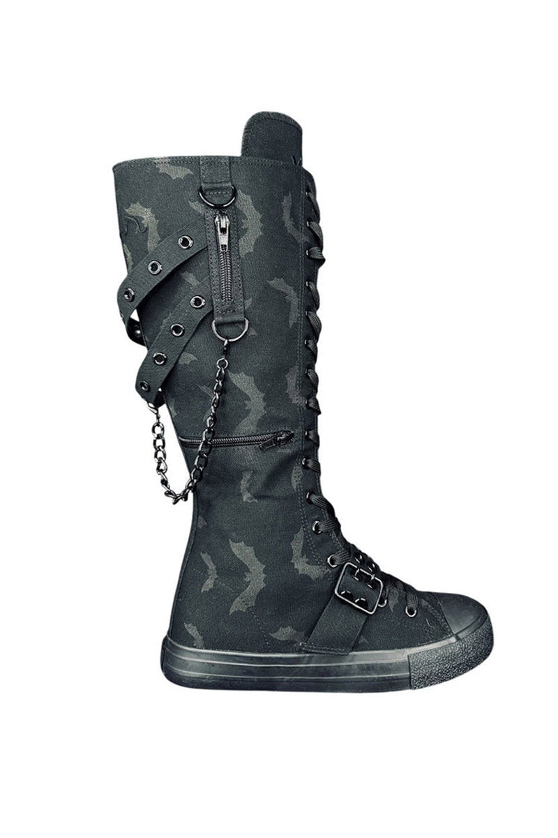 Black boot with chain and decorative elements on a white background