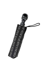 Gothic skull handle umbrella with bold bat stripe pattern for punk grunge and spooky streetwear accessories
